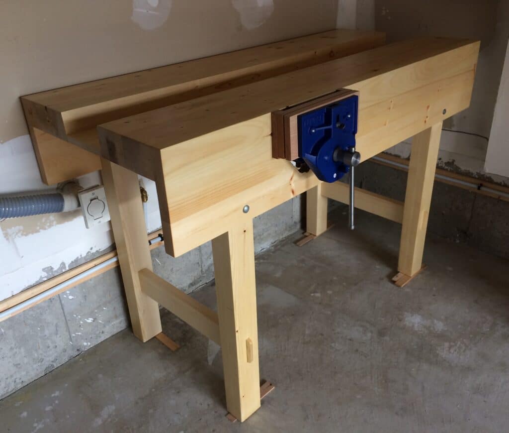 Workbench: made from dimensional SPF, 65cm x 150cm, 97cm high. Finish: two coats of shellac, wax. Eclipse 9" QR vise with red oak pads. — This was my first big project. It took me two months of weekends to make. Hand planing round corners of knotty two-by-fours was painful but valuable experience. I had to sharpen my plane every half an hour. Squaring the aprons was time consuming: I had to rebuilt them three times because they kept twisting overnight. I can safely say I learned a lot while building this bench by using hand tools only. Despite all mistakes and imperfections, I'm happy now. — When you make your project, remember: Never give up.