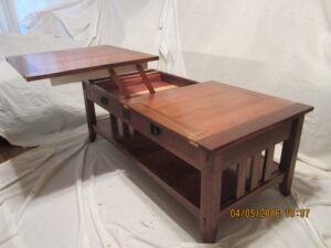 My coffee is of the Arts and Crafts style with a twist. The top is split and converts the table to a tray table.