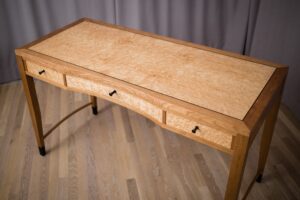 Writing desk for my wife. Made with quarter sawn cherry, Maple and birdseye maple veneer. Ebony leg cuffs and drawer pulls
