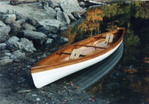 This is a 14 foot canoe made from okoume marine plywood and mahogany. It is a modified reproduction of a design by Henry Rushton - a canoe builder who lived in Canton, New York in the late 1880's. He was America's premier builder of double-paddle canoes which were very popular at the time. These canoes are usually propelled using a kayak paddle, but they can also be sailed. Mr. Rushton was known for his extremely lightweight and durable canoes some of which weighed about 10 pounds. My canoe weighs only 50 pounds and could be built even lighter if spruce were substituted for the mahogany.