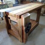 Poplar, Walnut, Oak, Cherry Rosewood, Black Locust and Spruce are all used in this bench. Also the vise handles are upcycled horse drawn machinery sprockets.