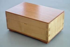 Variation on a Theme. Keepsake box in Sycamore and American Cherry without the curves made for our 6 month old grandson. Finished exactly the same as Paul's box: shellac and furniture polish. All wood hand prepared/planed.