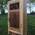 This is a wall cabinet I made for one of my high school teachers as a graduation gift. It's made from oak and walnut and finished with danish oil and wax.