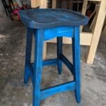 Bench stool made out of spruce. I finished it by staining it black, sanding most of it off and staining it once again with blue.