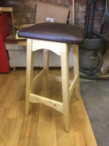 Made this out of scrap pine and faux leather left over from another project so I could sit at the bench when drawing plans. Finished in blond shellac.