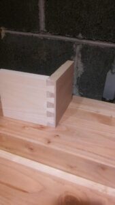 This is the corner of a half-blind dovetail made from pine. I'm making four drawers with half-blinds. In preparation, I've been practicing with cut-offs from past projects.