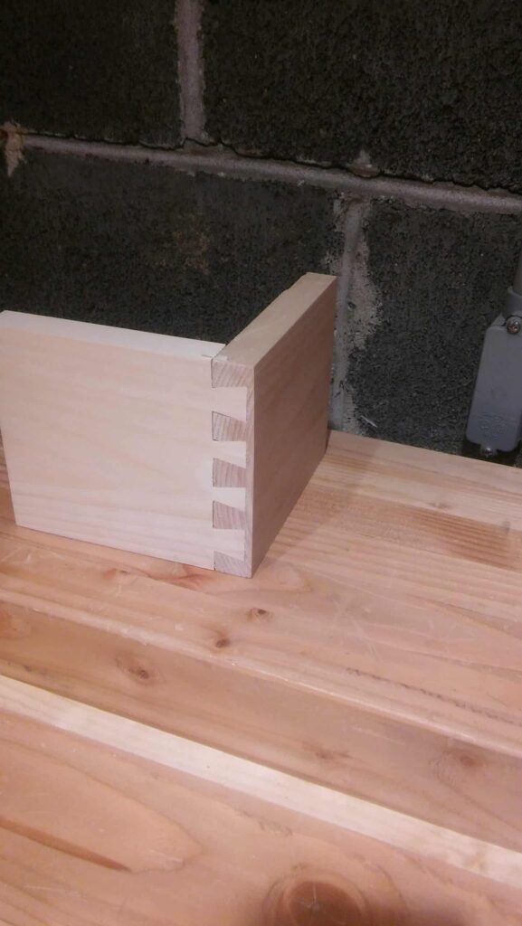This is the corner of a half-blind dovetail made from pine. I'm making four drawers with half-blinds. In preparation, I've been practicing with cut-offs from past projects.