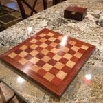 A relative's home suffered significant flooding and required removal of their Brazillian Cherry (Jatoba) hardwood flooring which had some historical sentimental value to them. I salvaged enough of it to make this chess board that might help carry their memories forward. I used the Brazilian Cherry for the border and dark squares, leaving some of the marks and dings in the border to preserve some character from its prior use as a floor, and then some maple I already had for the lighter color. I found the Brazilian Cherry very difficult to work, requiring near constant tool sharpening. Finished with shellac / wax and presented as a Christmas gift last year.