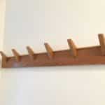 the oak coat rack secured to the wall