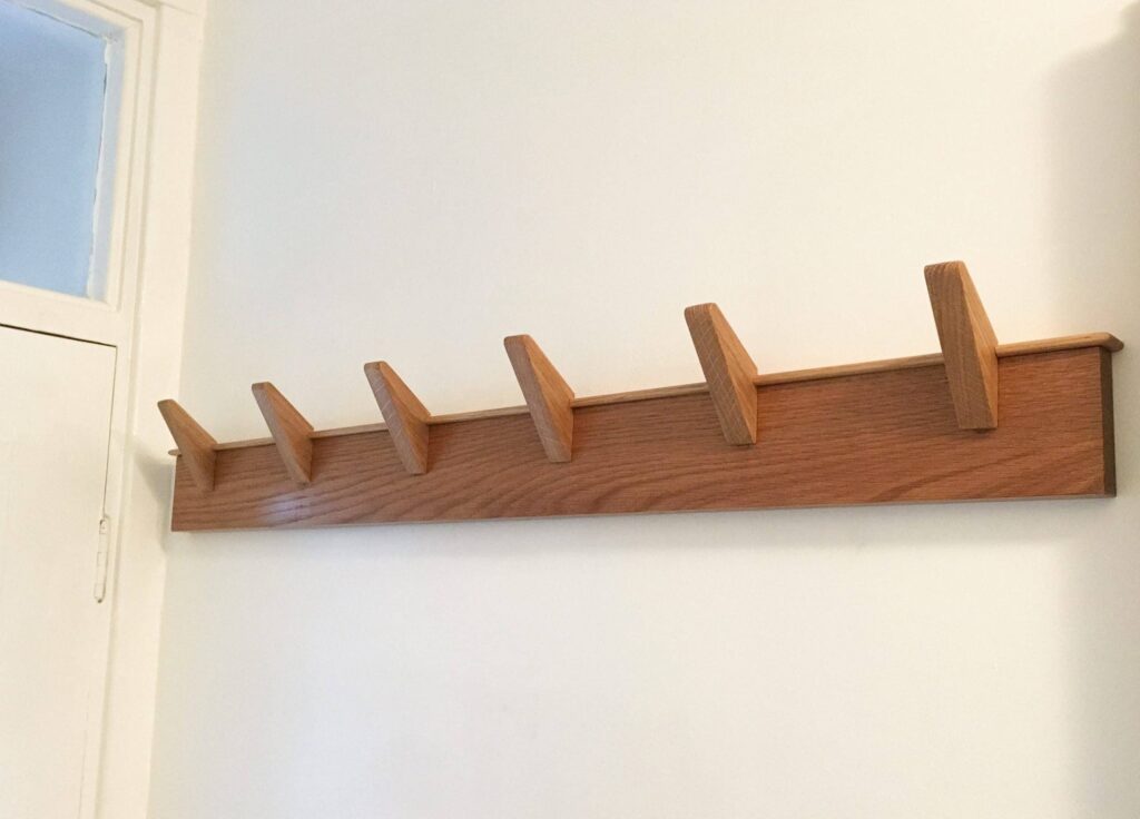 the oak coat rack secured to the wall