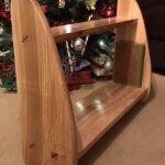 Book shelf for my son who is 5 months old. Ash construction with wedged mortises with padauk accents.