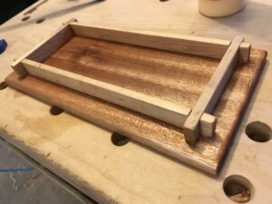 I made this wooden tray as Christmas gift for my sister's knitting needles and rings. The base is mahogany and the sides are maple. I finished with a coat of boiled linseed oil.